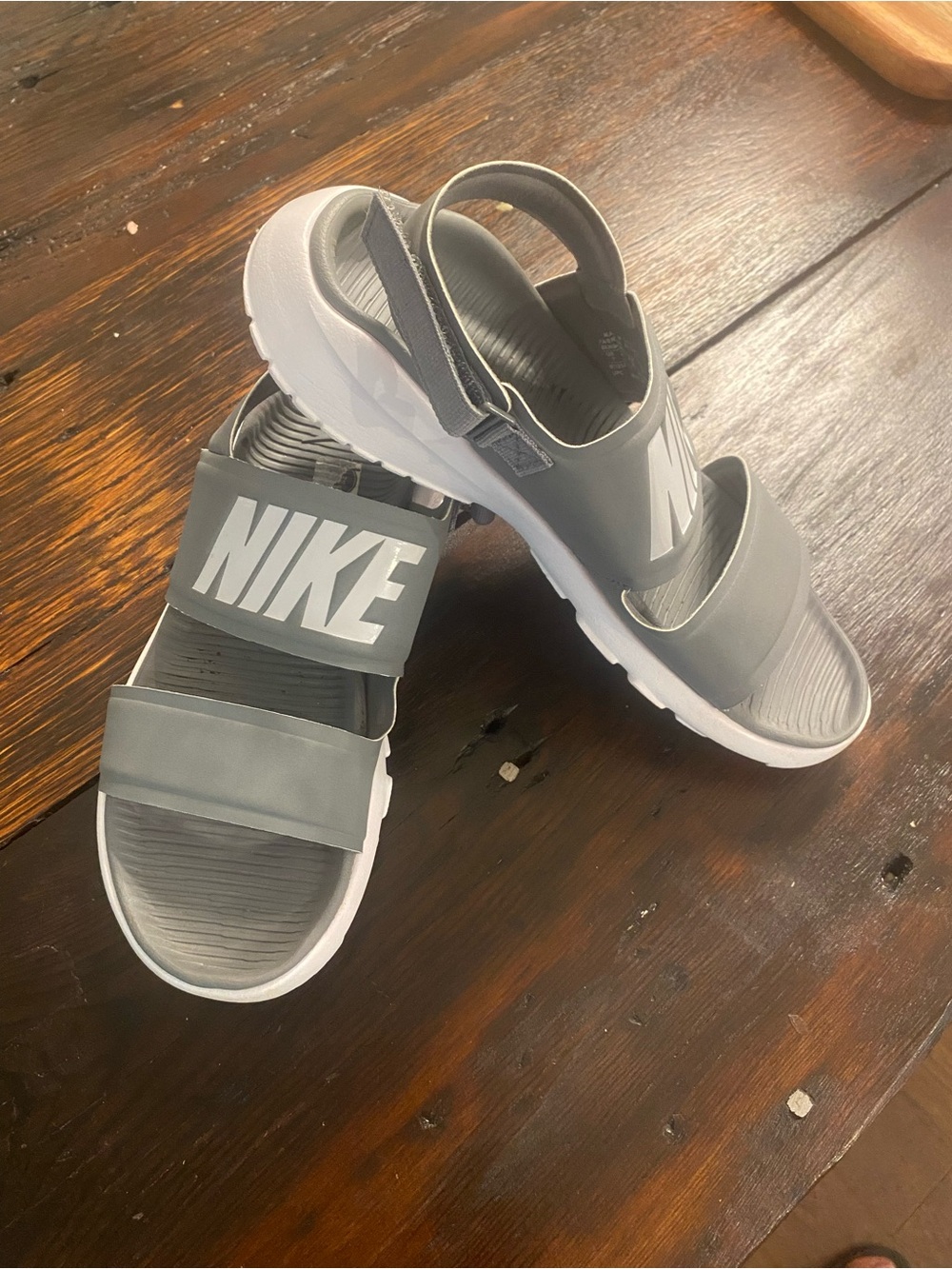 Nike Gray Strap Sandals with White Soles and Bold Logo